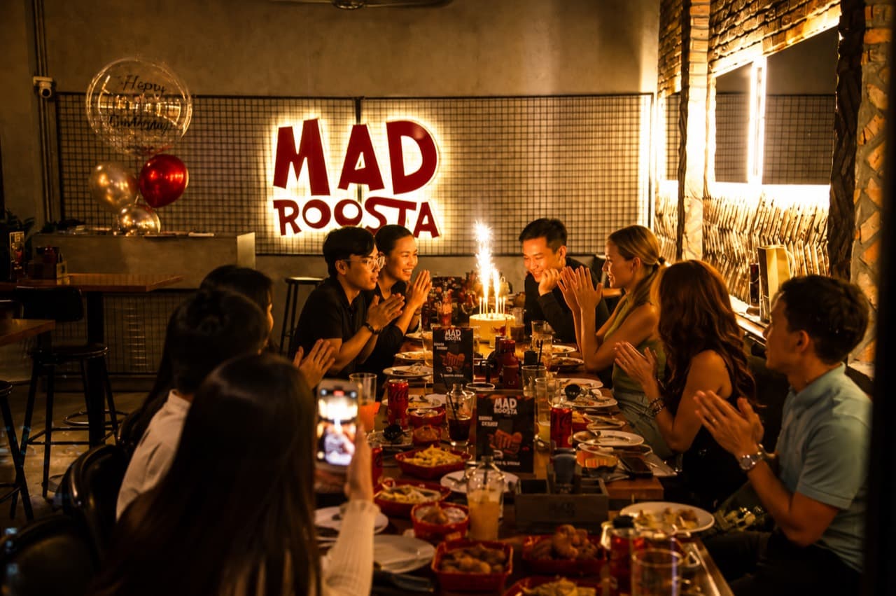 Group birthday dinner with cake at MAD ROOSTA